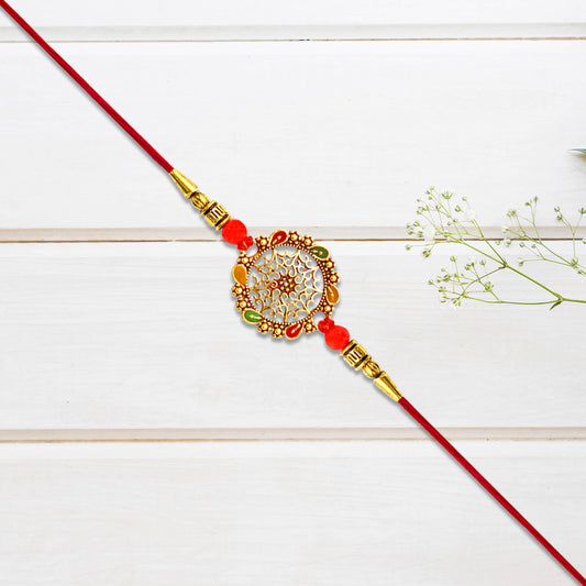 Intricately Designed Circular Rakhi With Multicolor Accents And Red Thread For Rakshabandhan