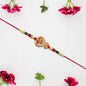 Designer Rakhi With Veena And Flower Charm