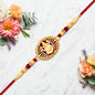 Traditional Ganesha Rakhi With Golden Finish And Sacred Red Thread
